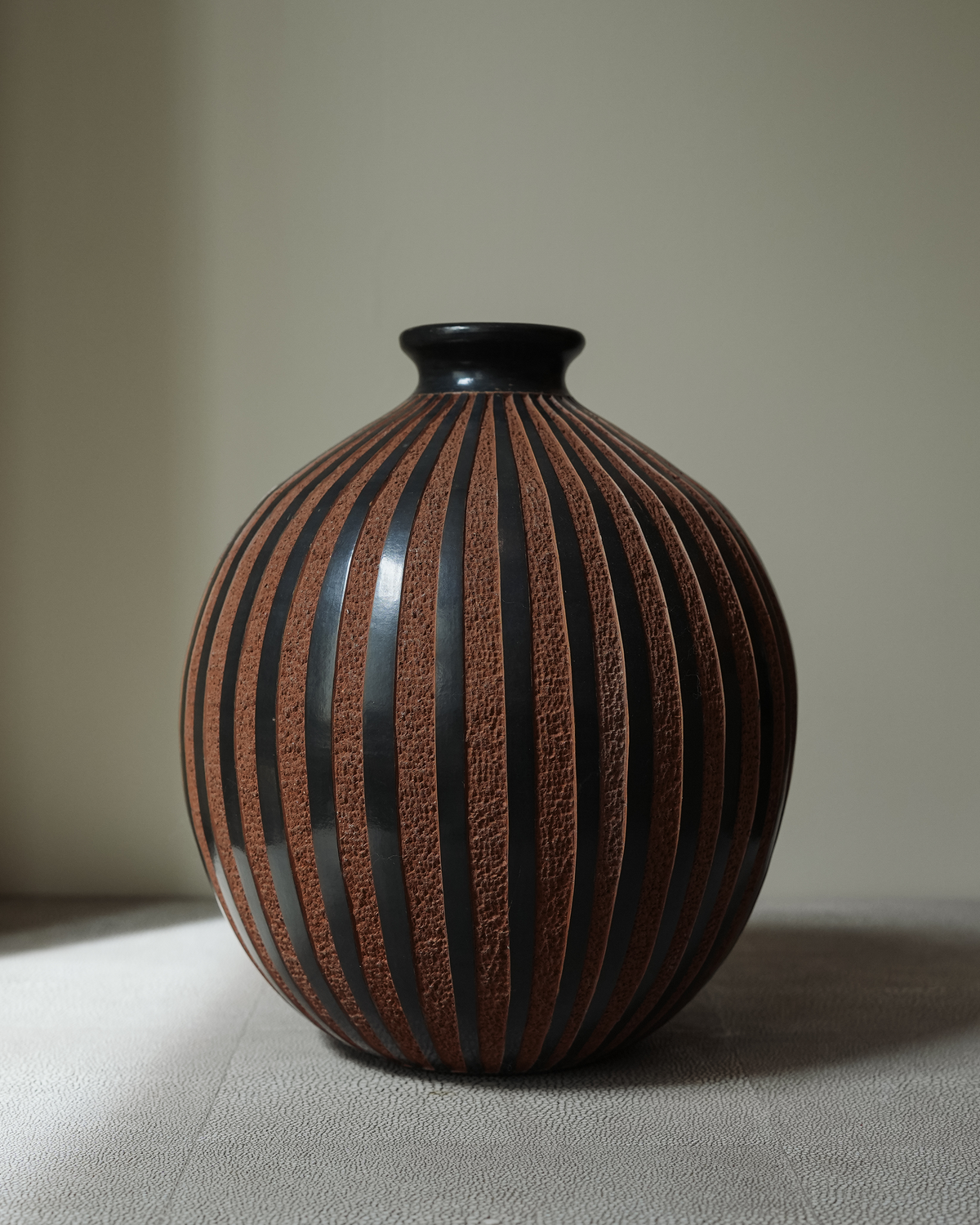 Amapola: handmade Nicaraguan ceramic round vessel with glossy black and textured terracotta vertical stripes
