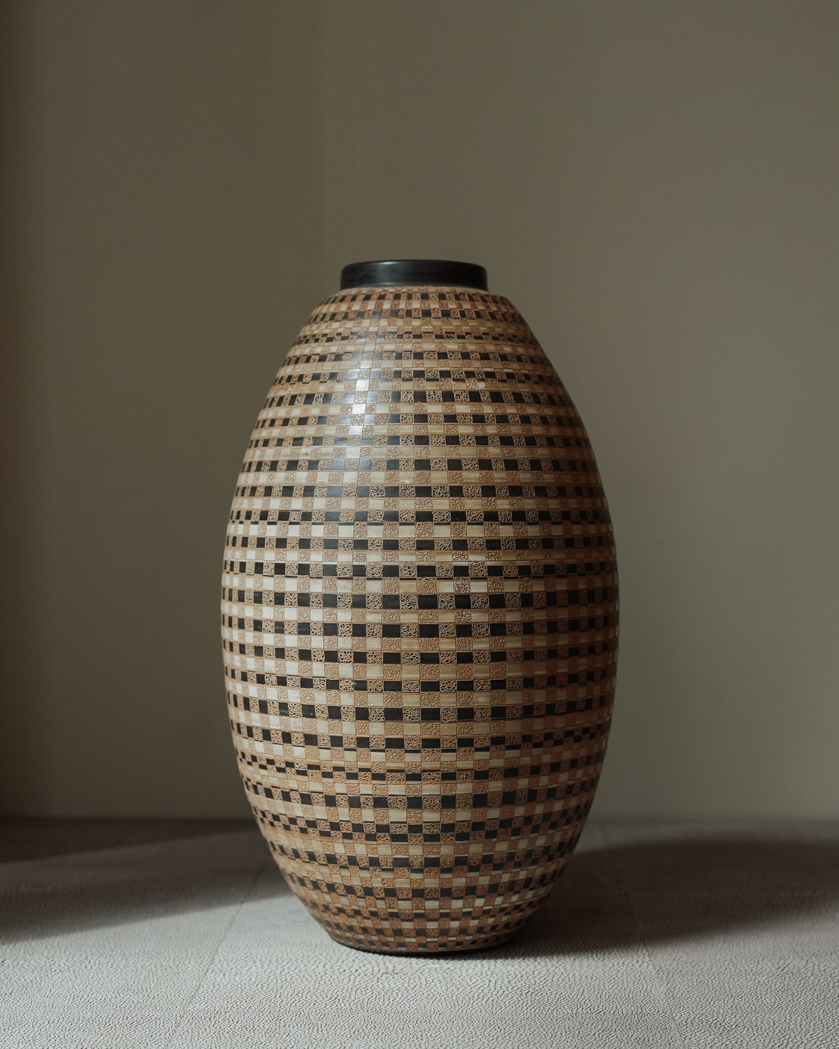 Calisto: handmade Nicaraguan ceramic tall egg-shaped vessel with a black and cream woven chequered pattern