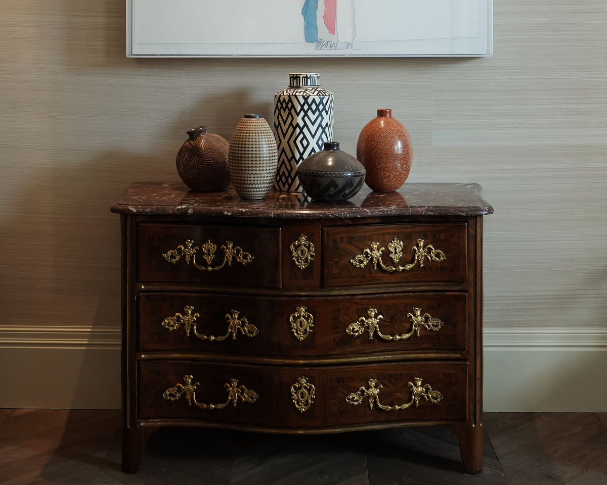 Siddeley Ceramics vessels displayed on an antique marble-topped chest of drawers