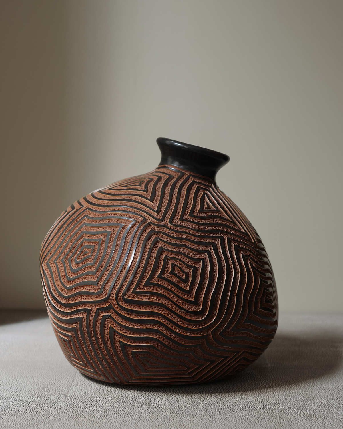 Etrana: handmade Nicaraguan ceramic brown vessel carved with a concentric maze pattern