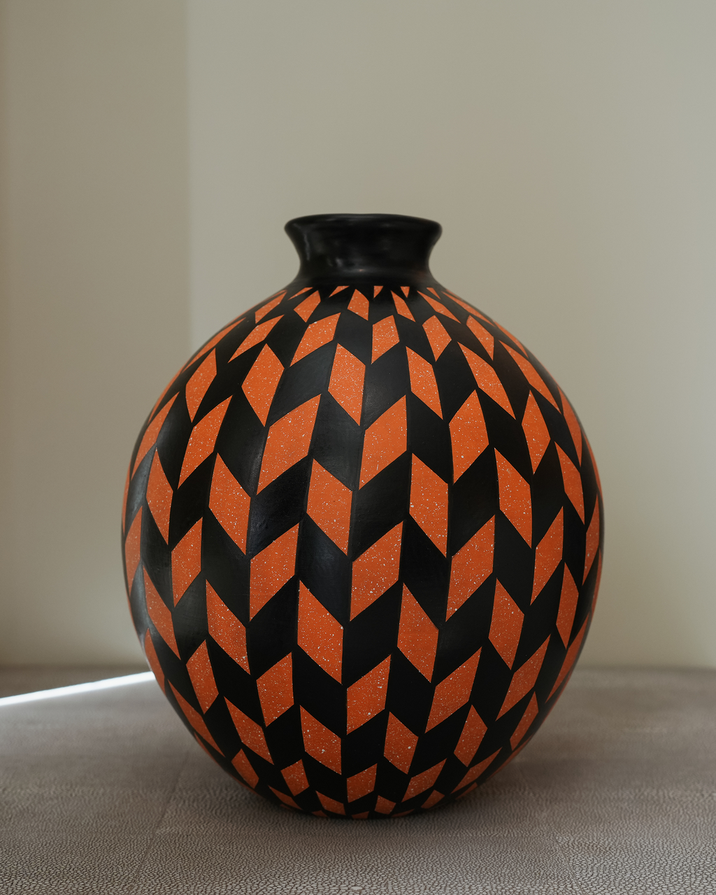 Hibiscus: handmade Nicaraguan ceramic round vessel with a bold orange and black chevron pattern