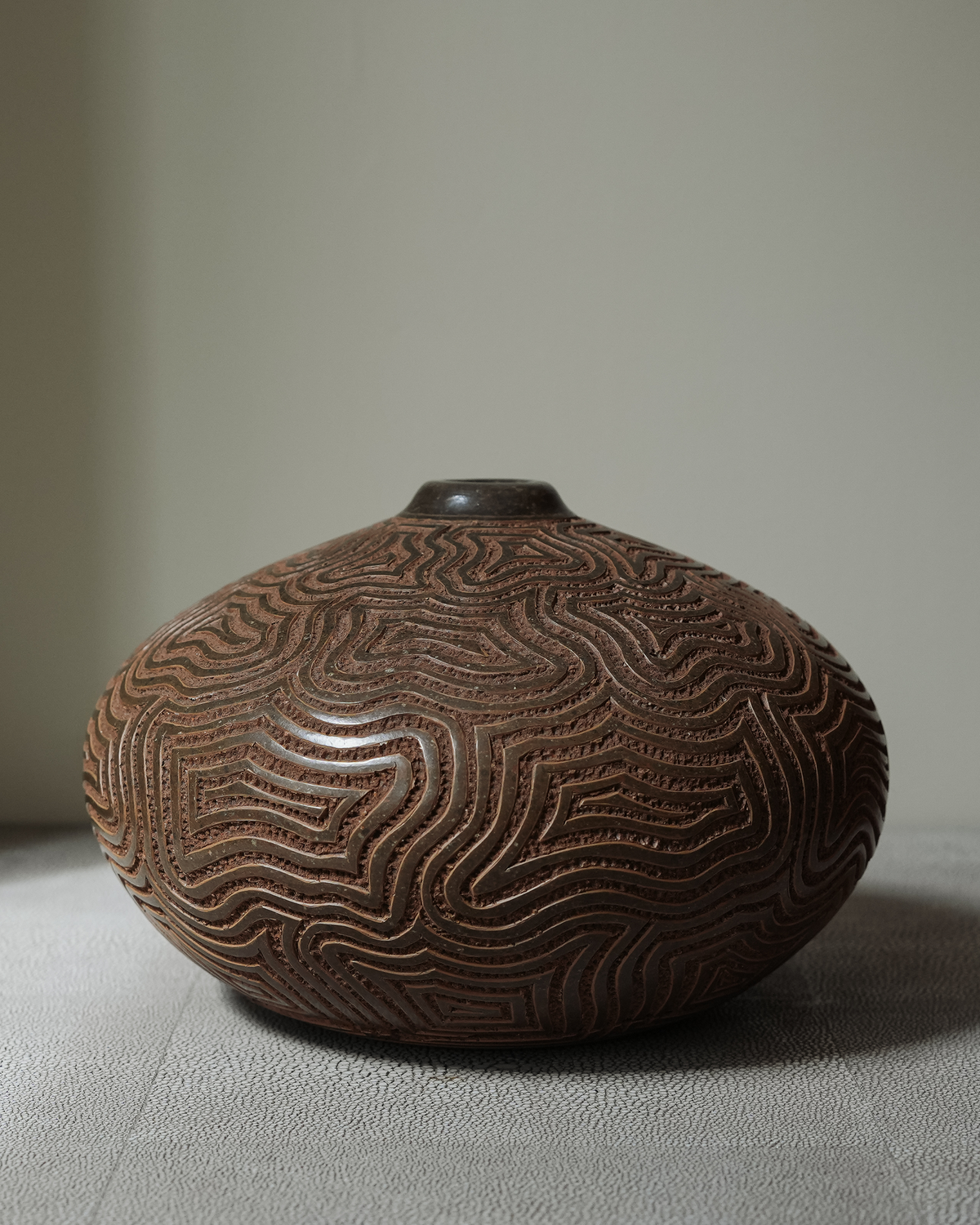 Orenda: handmade Nicaraguan ceramic wide, low brown vessel carved with flowing wave-like lines