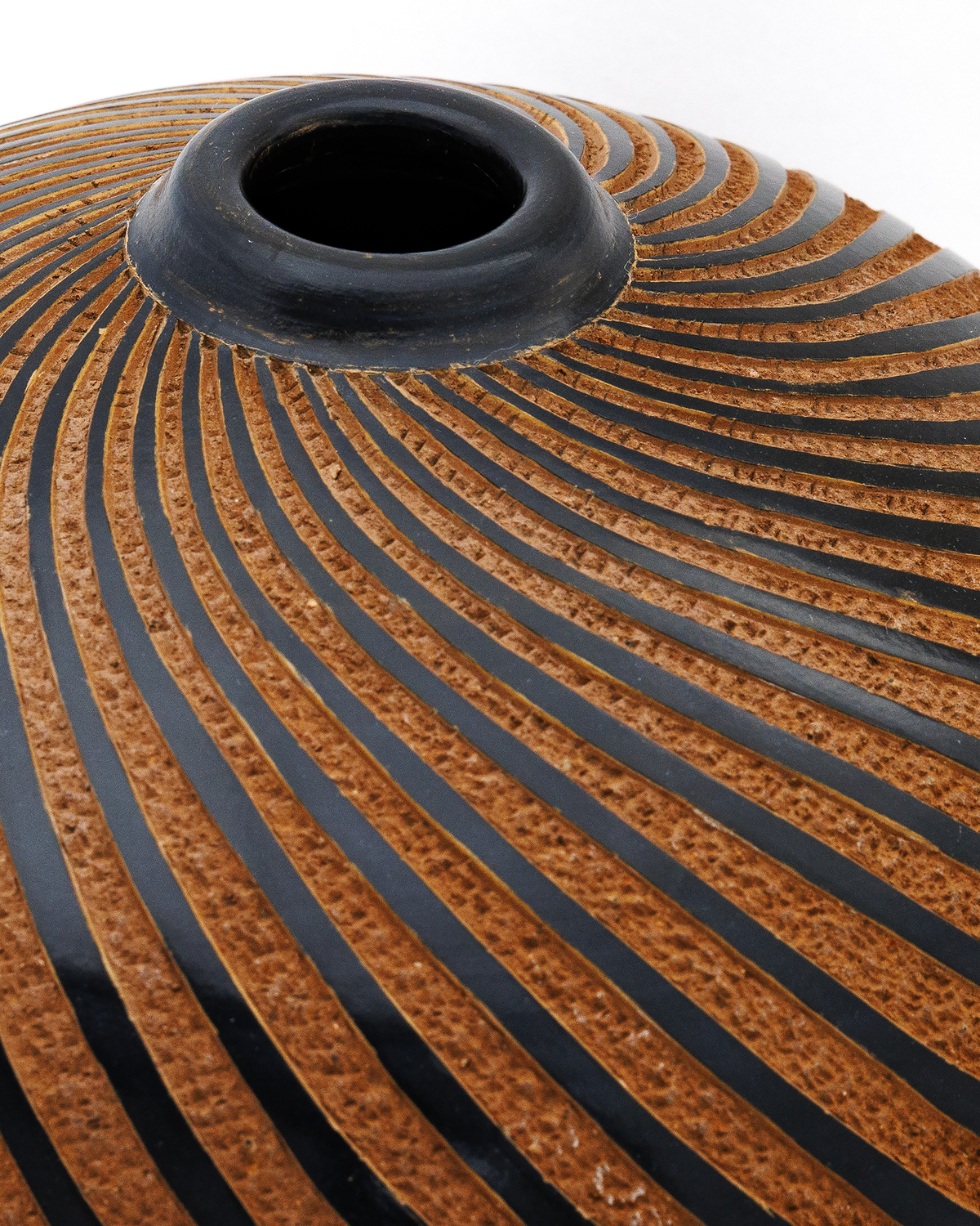 Pachira: handmade Nicaraguan ceramic round terracotta vessel with black spiral stripes, close-up of the neck and spiral