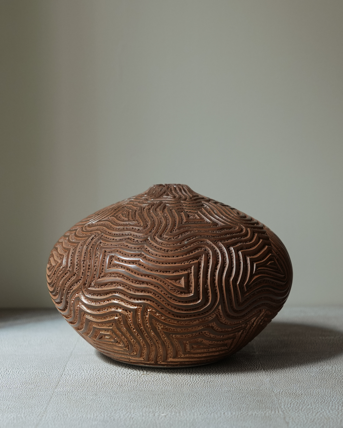 Serrano: handmade Nicaraguan ceramic round terracotta vessel deeply carved with wavy lines