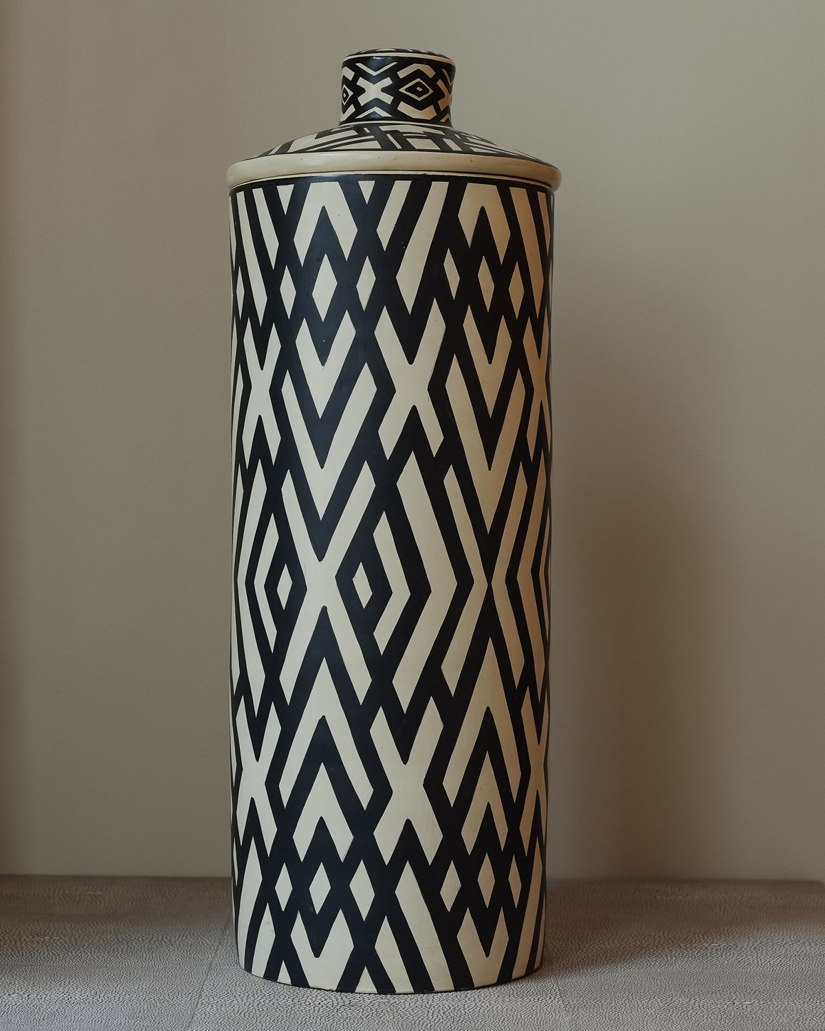 Xilapa: handmade Nicaraguan ceramic tall lidded jar with a black and white zigzag diamond pattern
