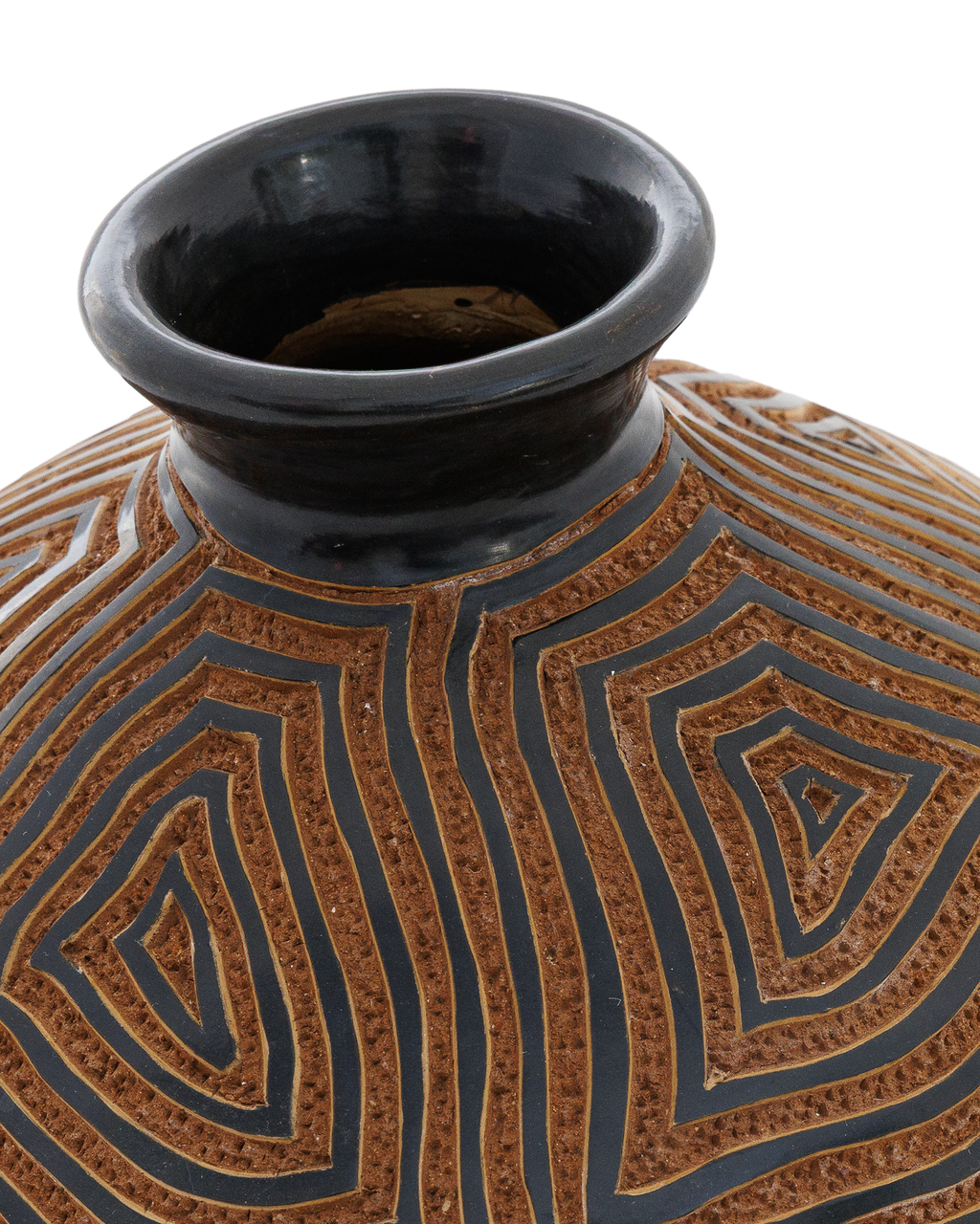 Amaru: handmade Nicaraguan ceramic rounded terracotta vessel carved with concentric maze-like lines and a black glazed neck, close-up of the black glazed neck